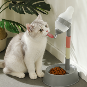 Cat drinking from KittyVerse elevated water bowl with ball drinker